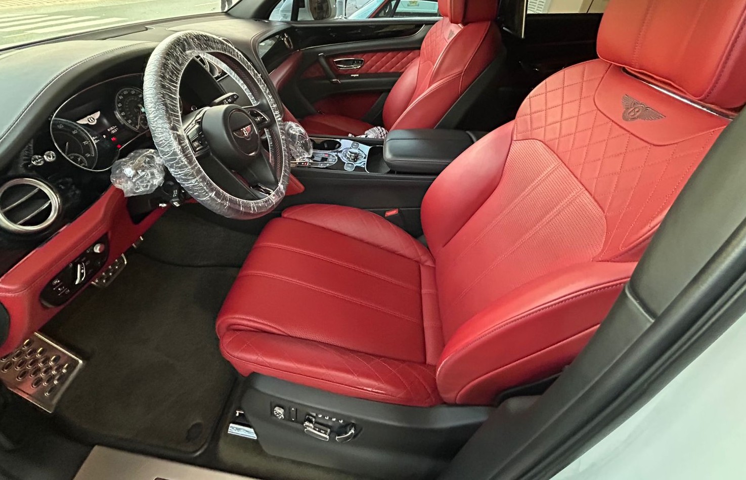 Red Bentley leather cabin with diamond-stitched front seats, dashboard and centre console